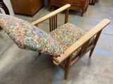 a wooden chair with a floral seat cushion in a room