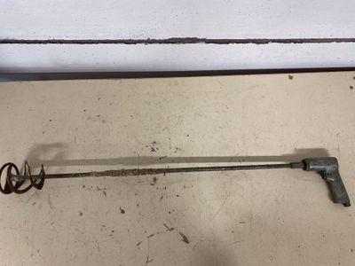 a metal object that is on the floor next to a wall