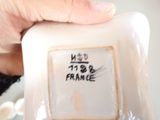 a person holding a small white plate with a picture on it