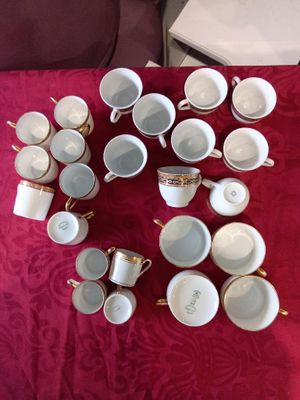 a lot of cups and saucers sitting on a table