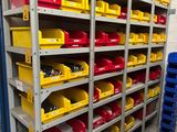 many bins on the shelves in the warehouse