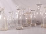 a lot of glass bottles that are sitting on a table