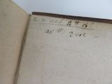 an old book with writing on it sitting on top of a table