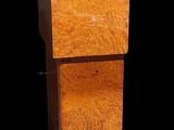 a tall wooden cabinet with a drawer underneath it