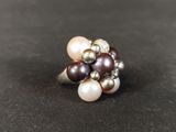 an image of a close up of a ring with pearls on it