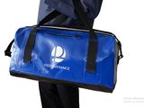 a man holding a blue duffel bag with a logo on it