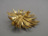 an image of a gold plated brooch with leaves on it