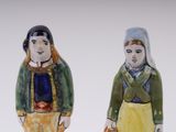 two salt and pepper shakers in the shape of a man and a woman