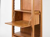 an image of a wooden bookcase with drawers and shelves