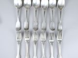 six spoons and six forks arranged in a row on a white surface