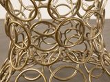 a gold metal table with a circular design on it
