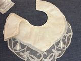 a picture of a baby ' s bib with a lace collar on it