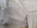 the label on the top of a white dress has a crochet pattern