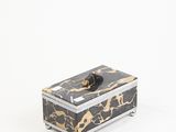 black and gold marble box with a black handle on a white background