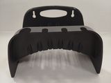 a black plastic object that is on a white surface