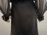 the back view of a black dress with sheer sleeves