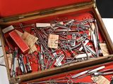 many different types of scissors in a wooden case