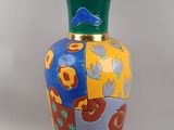 a colorful vase that is sitting on a table