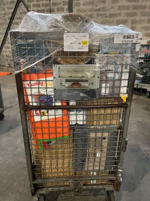 a metal cart with many items in it in a warehouse