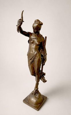 statue en bronze d'une femme tenant un oiseau sur un piédestal