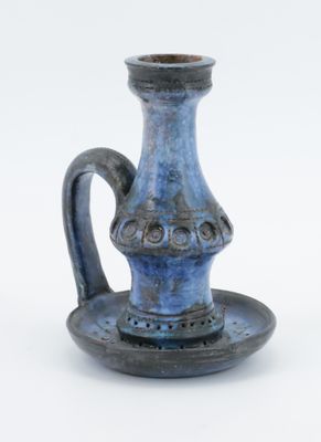 a small blue vase with a saucer on a saucer