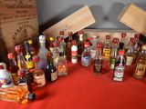 many bottles of alcohol on a table with a red table cloth