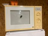a yellow microwave sitting on top of a white microwave oven