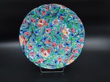 an image of a colorful plate sitting on top of a black table