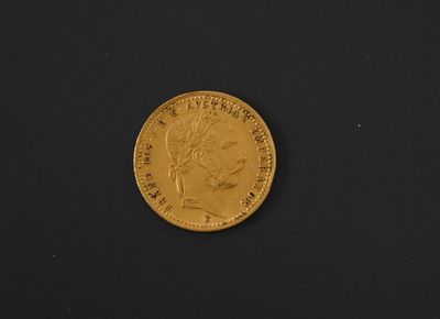 an image of a gold coin on a black surface