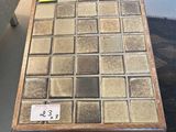 a small table with a glass tile top on it