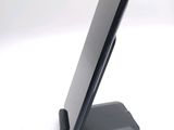 a cell phone that is on a stand on a table