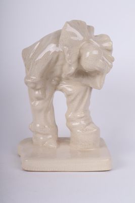 a small statue of a man with a bag on his back
