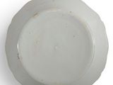 a white plate on a white surface with a gold rim