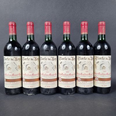 six bottles of red wine lined up in a row