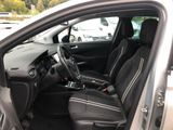 the interior of a car with the door open and the driver ' s seat down