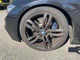 a black car that has a bmw wheel on it