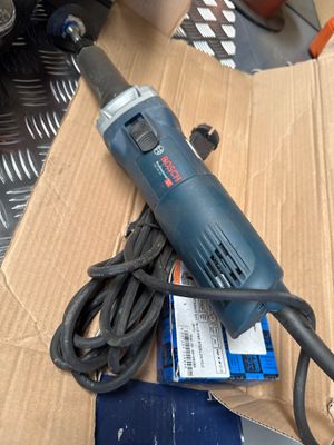 a corded drill on a cardboard box on a table