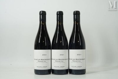 trois bouteilles de vin posées sur une table l'une à côté de l'autre