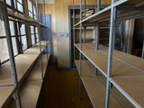 a long row of shelves in the middle of a room