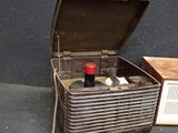 an old radio sitting on the floor next to a box