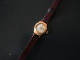 an image of a wrist watch on a black surface