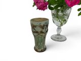 two vases with flowers in them next to each other