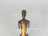 a small figurine of a man sitting on top of a table