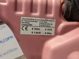 a pink machine that has a label on it