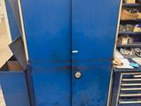 a blue cabinet with drawers and tools in it