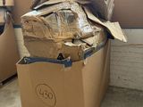 a box full of cardboard sitting on a pallet in front of a window