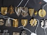 many different types of badges and tags on a table