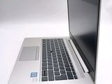 a laptop computer sitting on a white surface