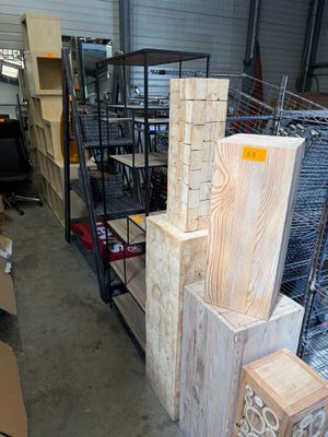 several stacks of wood are stacked on top of each other in a warehouse