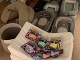 a pile of baby items on the floor in front of a window